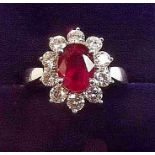A fine 18 carat white gold ruby and diamond cluster ring, size P