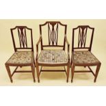 A set of three Edwardian mahogany dining chairs with pierced decorative splat (one carver and two