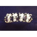 A 9 carat gold ring set five marquise cut sapphires and four pairs of diamonds, size O