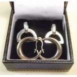A pair of 9 carat gold hoop earrings and a pair of silver stirrup earrings
