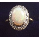 An 18 carat gold opal and diamond cluster ring, size N