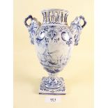 An old two handled handpainted urn form Delft vase with grape and foliage decorated handles, painted