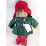 A Paddington bear with green coat