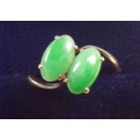 A 14 carat gold ring crossover set two green stones, size N