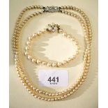 A Lotus simulated pearl necklace and a simulated pearl bracelet