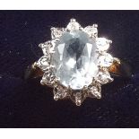 A 9 carat gold cluster ring set blue topaz and twelve diamonds, size O