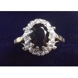 An 18 carat white gold sapphire and diamond cluster ring - the sapphire approx 1.5 carats, size N