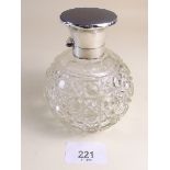 A cut glass scent bottle with silver and replacement blue stone lid