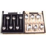 Two sets of silver teaspoons - one with stag finials and one with coffee bean terminals