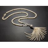 A matching Art Deco style 18ct white gold pearl and diamond set necklace with tassel pendant, the