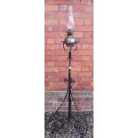 A wrought iron telescopic standard lamp with floral motifs - 178cm fully extended