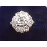 An 18 carat white gold ring set old cut diamonds - the central stone just under 1 carat - size L