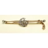 A Victorian diamond set bar brooch decorated moon and stars - unmarked but 9 carat gold and approx
