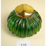 An Art Nouveau lustred green glass inkwell with brass lid