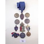 A group of commemorative medals and other school sporting medals