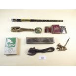 A group of collectables including Austrian Tiki lighter in box, dog form corkscrew, cow form tin