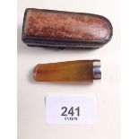 An amber and silver mounted cigarette holder - cased
