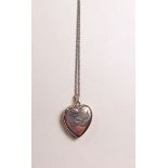A 9 carat gold heart form locket on fine spiral link 9 carat gold chain - total weight 4.2g