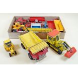 An assortment of farm vehicles including Dinky Aveling Barford Centaur Dump truck and shovel,