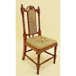 A Victorian mahogany childs chair with barley twist and scroll back and tapestry upholstery