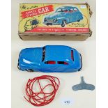 A vintage Chad Valley remote control tin plate clockwork car with key - boxed