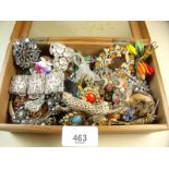 A box of vintage brooches and costume jewellery