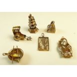 Five 14k gold Chinese charms, 5.2g and a yellow metal charm