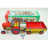 A Kovap tin plate clockwork tractor and trailer - boxed