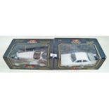 Two Burago boxed cars