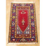 A decorative rug with red ground and blue border - 983 x 127cm