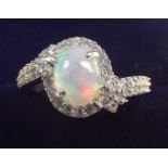 An Ethiopian opal set silver cross over ring, size Q