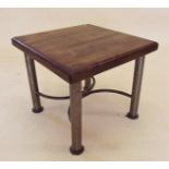 A hardwood occasional table with hammered metal legs and curved stretchers, by RK