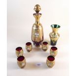 A ruby glass liqueur decanter with six glasses and a similar green and gilt glass vase