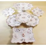 A Victorian Swansea style dessert service with floral decoration, comprising comport, three