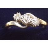 An 18 carat gold and platinum diamond crossover ring - size N