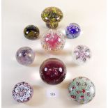 A collection of nine glass paperweights