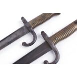 Two Chassepot bayonets, each with 22½ ins single edged fullered blade, brass grips (2)