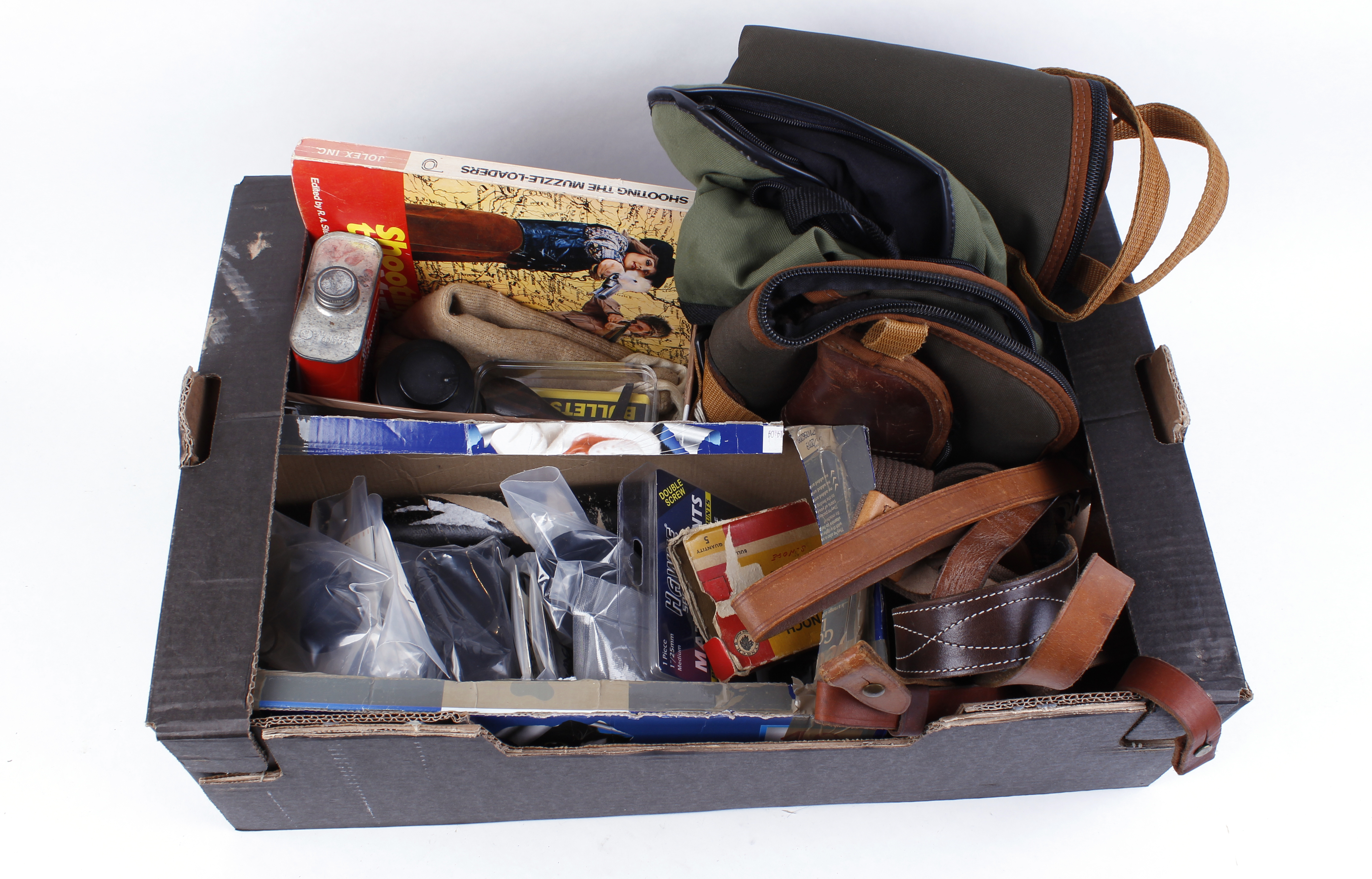 Box containing two gun slips, scope covers, canvas and leather rifle slings, moderator, black powder