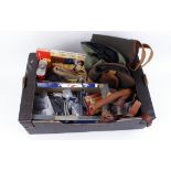 Box containing two gun slips, scope covers, canvas and leather rifle slings, moderator, black powder
