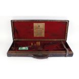 Oak and leather double gun case with brass corners, red baize fitted interior for 30 ins barrels,