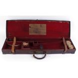 Leather motor case with brass corners, red baize lined fitted interior for up to 30 ins barrels,