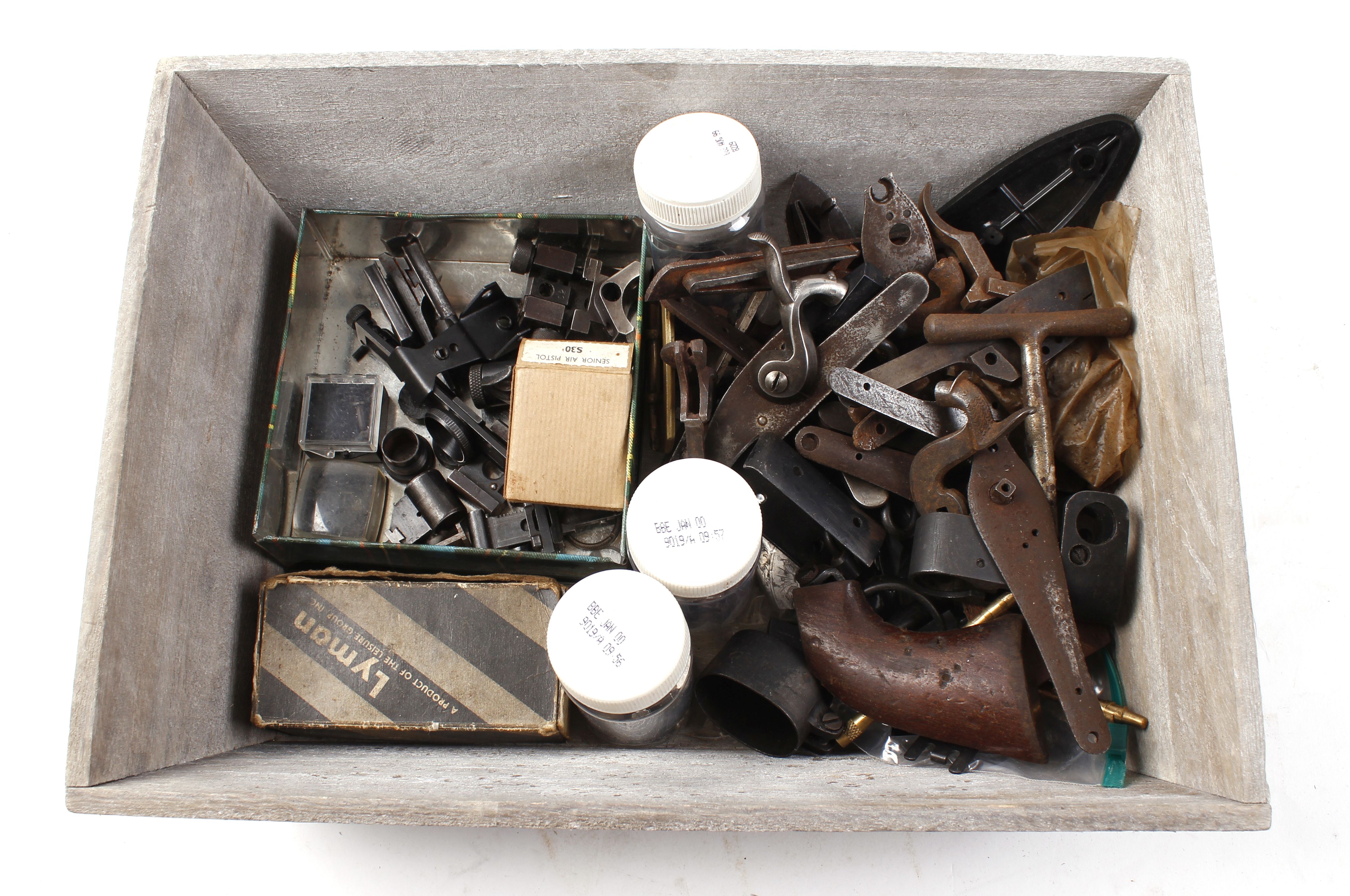 Tray of various gun parts: locks, sights, hammers, dies, etc