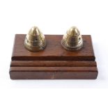 Two WWI British No.80 brass artillery fuse timers, polished and mounted on a wooden base to form a