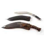 Two Kukri knives, each with nickel plated blades, metal mounted wood grips in leather covered