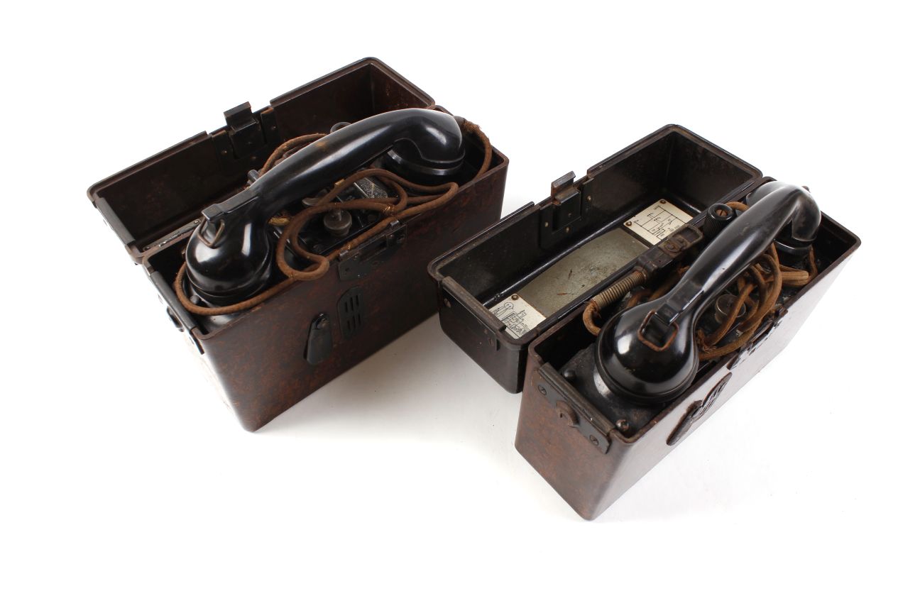 Two WWII German field telephones, in original bakelite cases with German phonetic alphabet labels,