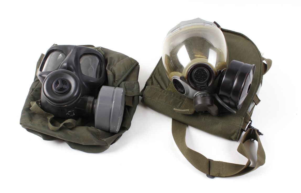 Two British issue gas masks in carry cases