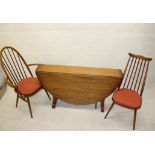 An Ercol drop leaf table, together with four chairs and two matching carvers all with stick backs (