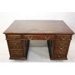 A 19th Century Hobbs & Co oak partners desk, having two banks of four graduated drawers with one