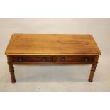 A 19th Century walnut veneered coffee table, of rectangular form with frieze drawers, on four turned