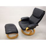 A navy blue leather laminated easy chair and footstool,